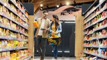 A couple in a store with many food packagings and sustainable products