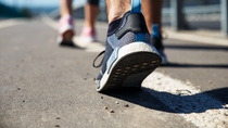 Feet of an athlete couple running on a pathway. Feet of an athlete couple running on a pathway.