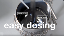 Close-up of a metal container mixing anode slurry with Licity binder. "Easy dosing" text overlays the image. Close-up of a metal container mixing anode slurry with Licity binder. "Easy dosing" text overlays the image.