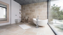 An amazing spacious bathroom with sand beige tiles