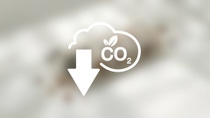 Icon on blurred background featuring a cloud-like form with "CO2" in the center and an arrow pointing downwards    