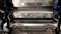 A slot die with soft touch nozzle applies acResin® evenly and precisely on PET film.