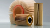 Three air filters with pleated paper designs are displayed against a gray background. They vary in shape and size, conveying a clean, industrial feel.