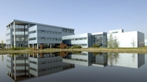 A group of buildings seen from across a waterfront at the BASF site in Heerenveen. 