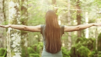 Woman spreading her arms in the forest back view: balance, spirituality and nature concept; Shutterstock ID 774241555; purchase_order: 20220801; job: Präsentation; client:  BASF SE, ED/KL - H201, Marie Schütz; other: BASF SE, GBH/IM - D211, Matthias Baque