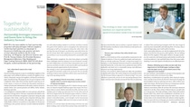 Two-page magazine spread titled "Together for Sustainability." The left page discusses a partnership in the pulp and paper industry, featuring a large image of a paper reel. The right page highlights a strategy for sustainable solutions, with images of two businessmen in professional attire, one seated and leaning on coating machinery the other one is standing in front of a white wall. 