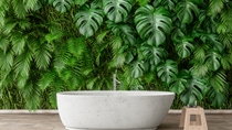 Modern bathroom with a white oval bathtub on a wooden floor, set against a lush green wall of tropical leaves. Modern bathroom with a white oval bathtub on a wooden floor, set against a lush green wall of tropical leaves.