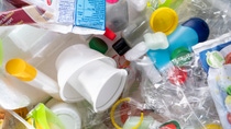 A chaotic mix of plastic waste, including bottles, caps, food packaging, and containers. A chaotic mix of plastic waste, including bottles, caps, food packaging, and containers.