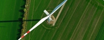Aerial view of wind turbine with shadow on agricultural field. Aerial view of wind turbine with shadow on agricultural field.