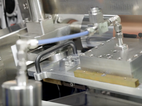Close-up of industrial machinery with metal plates and connected tubes. Close-up of industrial machinery with metal plates and connected tubes.