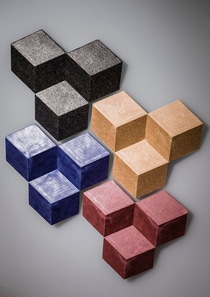 Colorful 3D cubes in black, beige, blue, and pink form a geometric pattern against a gray background. Colorful 3D cubes in black, beige, blue, and pink form a geometric pattern against a gray background.