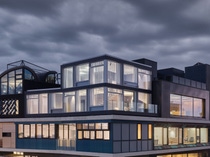 The image shows the STEP2 unit featuring BASF upcycling solutions, positioned at the top level on the corner. The unit is shown with lights on, contrasting with a cloudy dark sky in the background. Credit: Zooey Braun The image shows the STEP2 unit featuring BASF upcycling solutions, positioned at the top level on the corner. The unit is shown with lights on, contrasting with a cloudy dark sky in the background. Credit: Zooey Braun