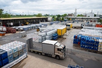 Industrial yard with numerous stacked barrels and containers. Trucks are parked amid organized rows.
There are stacks of industrial C-IBC packaging at container handling facilities of BASF’s Ludwigshafen site. 
Credit: BASF