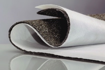 A sheet of roofing material and a white membrane, bent into a curved shape. A sheet of roofing material and a white membrane, bent into a curved shape.